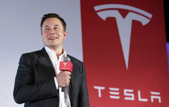 Tesla Motors CEO Elon Musk speaks to the media next to its Model S during a press conference in Hong Kong. 25JAN16 SCMP/ Nora Tam