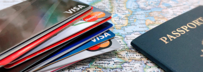 passport-and-credit-cards-on-map-1400x500